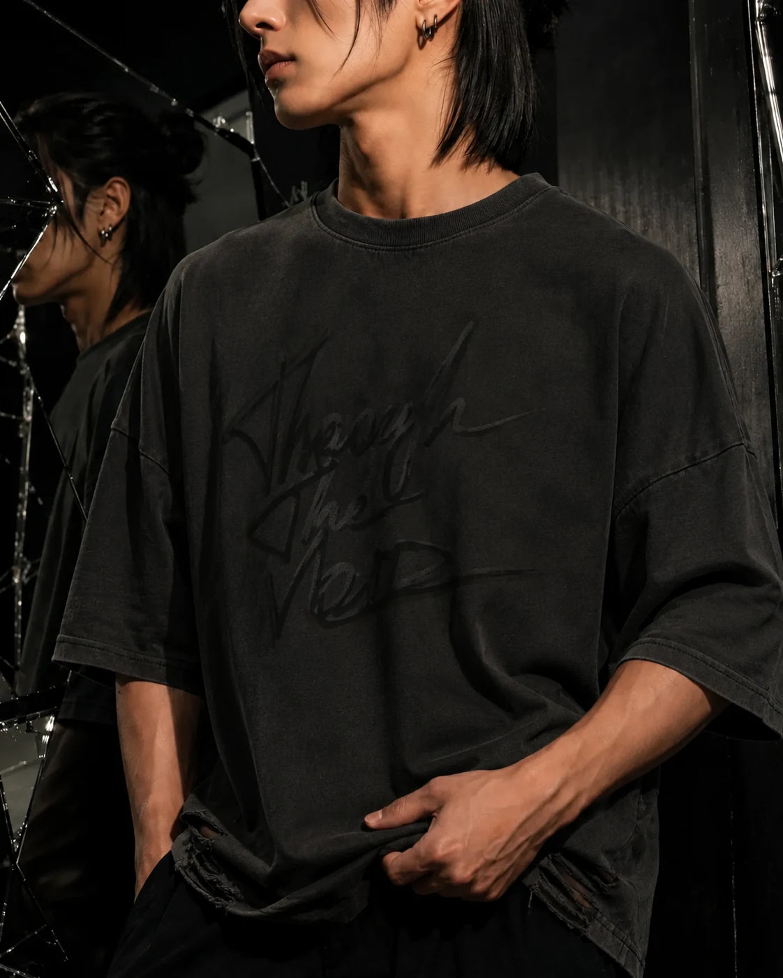Close garment study of the washed black AFTERFORM VOID Washed Raw-Hem T-Shirt.