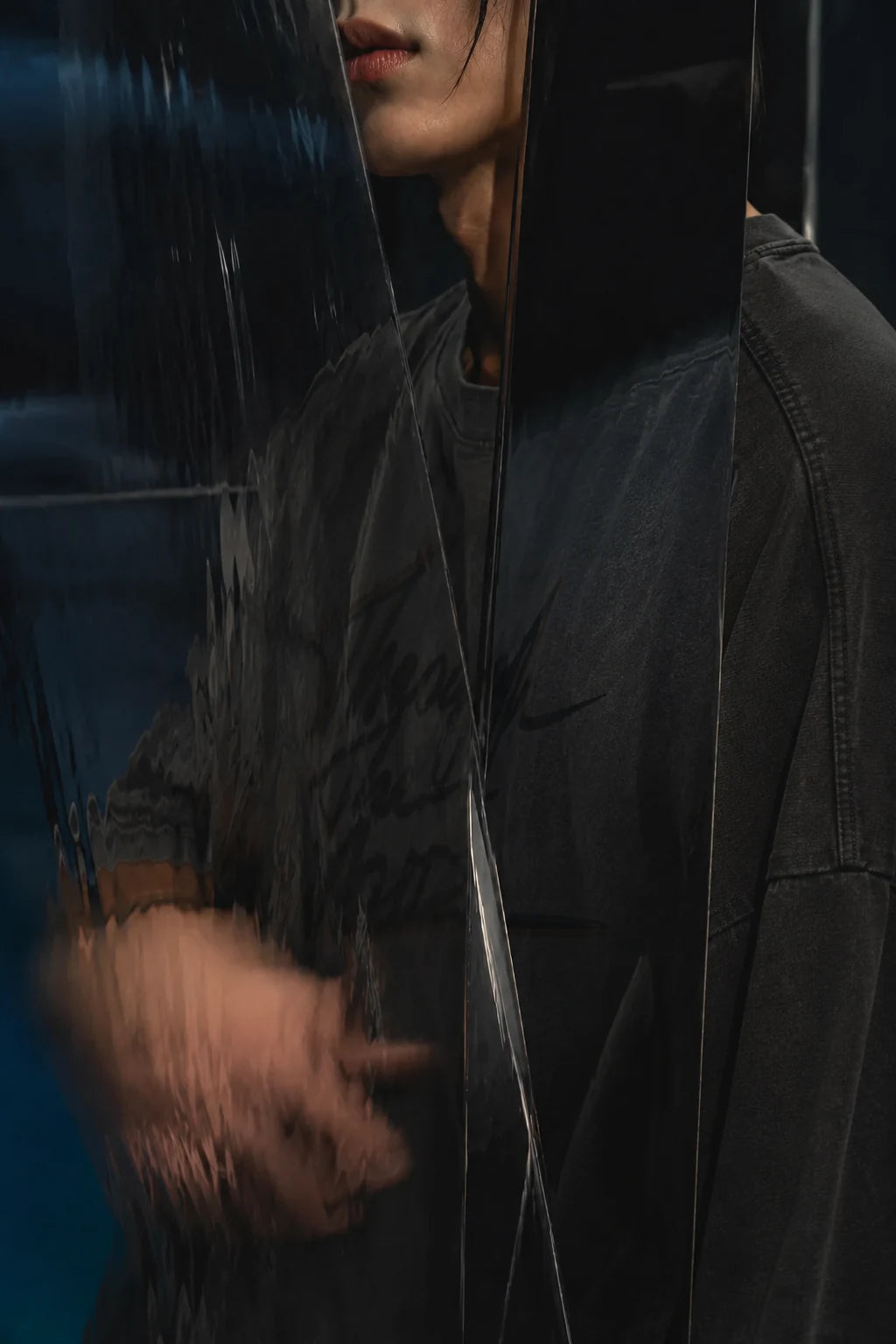 Washed black AFTERFORM VOID Washed Raw-Hem T-Shirt reflected through dark panels.